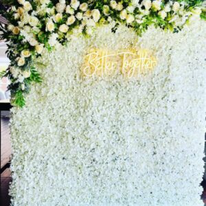White Flower Wall with corner flower arrangement